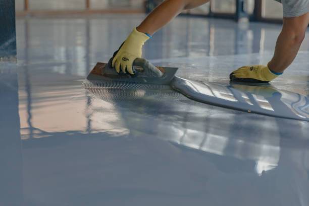 worker-applies-gray-epoxy-flooring